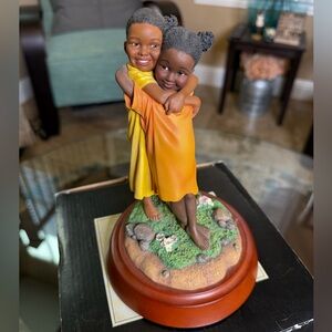 Thomas Blackshear Ebony Visions Figurine Double Hug is retired.